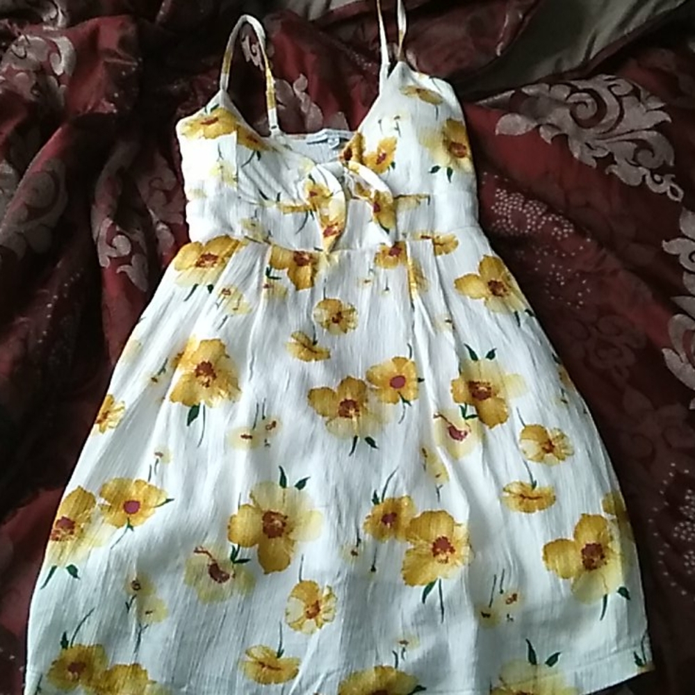 A white dress covered with yellow flowers